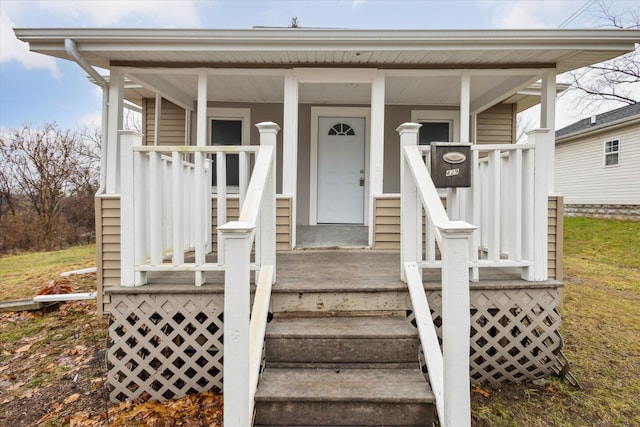 view of exterior entry with covered porch