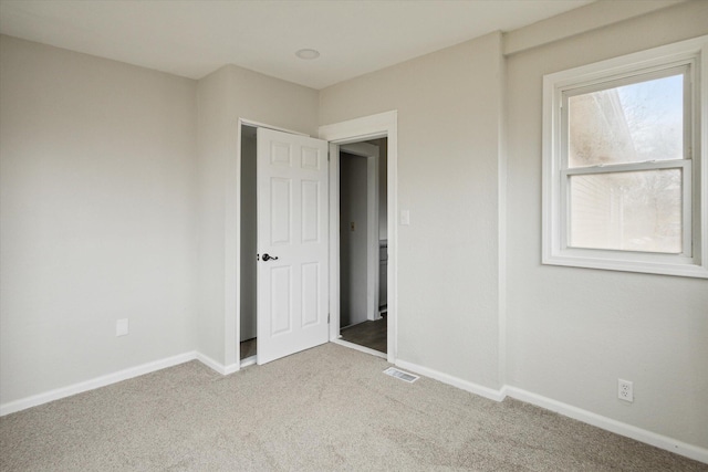 unfurnished bedroom with light colored carpet