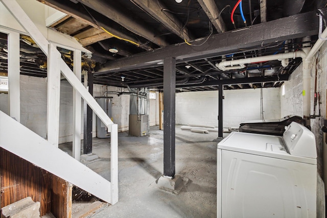 basement featuring water heater and washer and clothes dryer