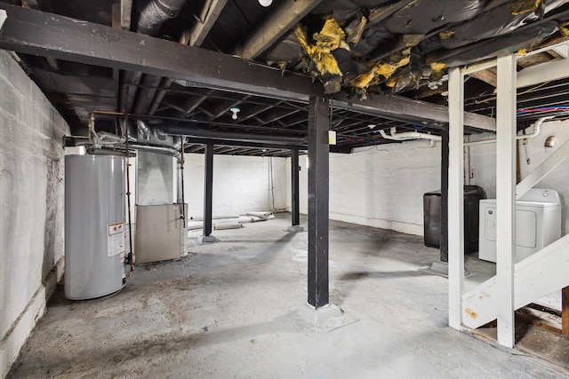 basement featuring heating unit, separate washer and dryer, and water heater