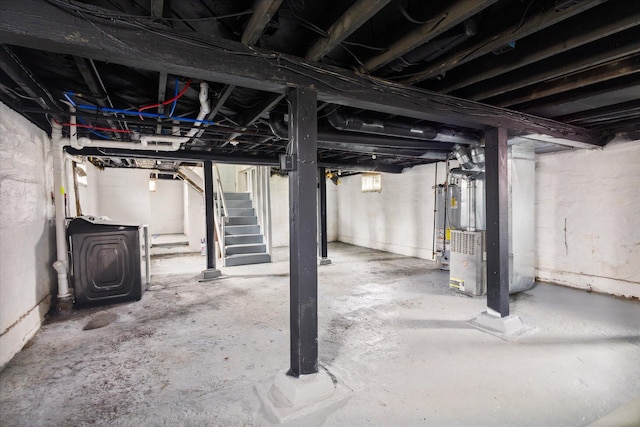 basement with washer / clothes dryer, heating unit, and gas water heater