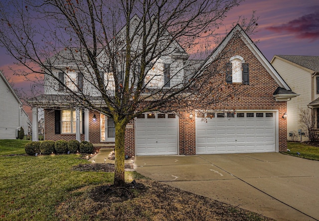 view of front of home with a yard and a garage