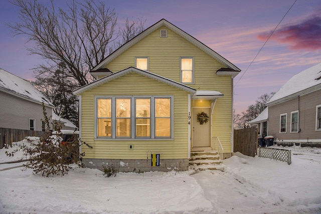 view of snow covered rear of property