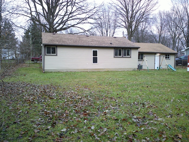 rear view of property featuring a yard