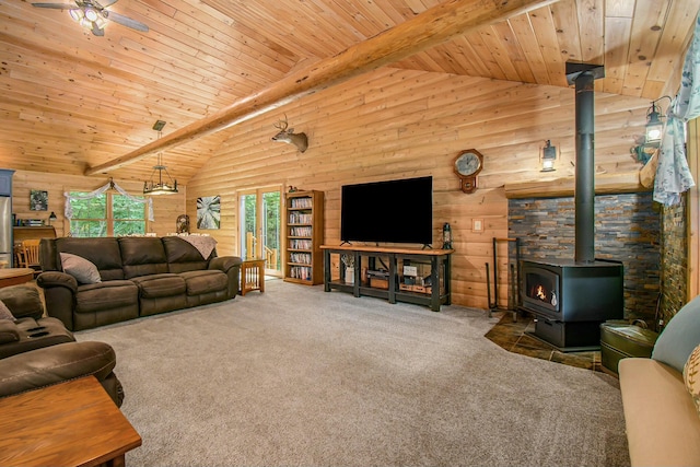 carpeted living room featuring a wood stove, a wealth of natural light, beamed ceiling, and high vaulted ceiling