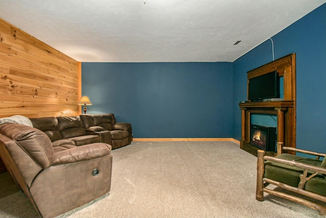 living room featuring wood walls and carpet floors