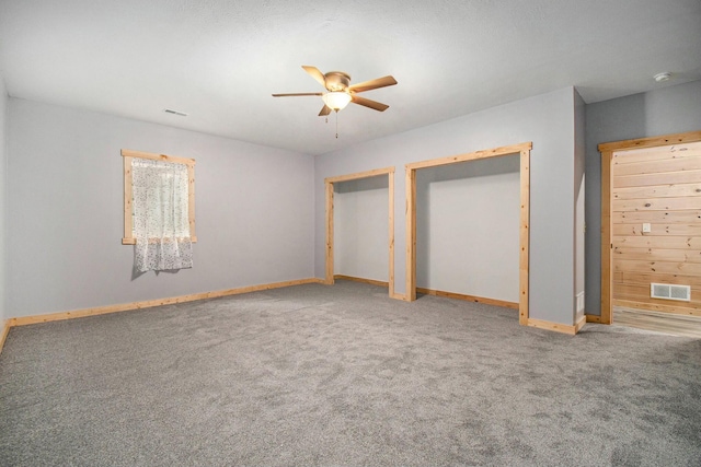 unfurnished bedroom featuring carpet and ceiling fan