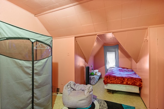 carpeted bedroom with lofted ceiling