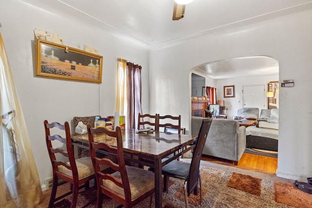 dining room with ceiling fan and wood-type flooring