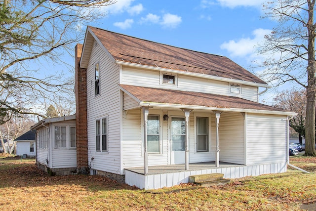 view of front of home with covered porch and a front yard