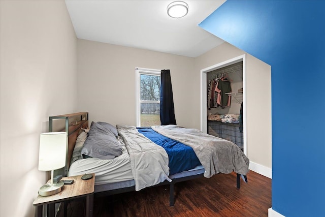 bedroom featuring a closet and dark hardwood / wood-style floors