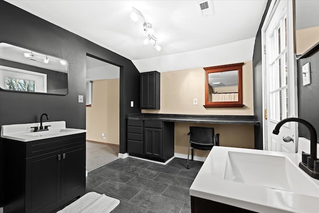 bathroom featuring vanity and vaulted ceiling