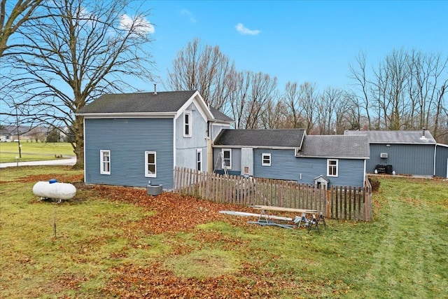 back of house with a lawn