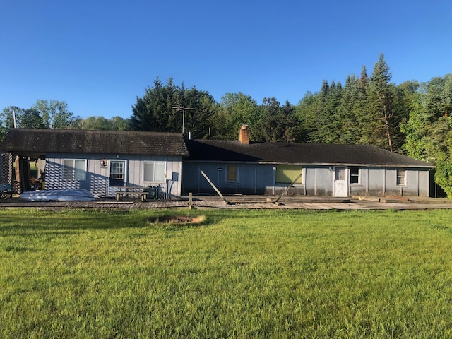 back of property featuring a lawn