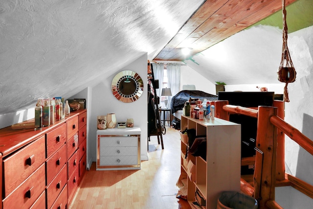 bonus room featuring vaulted ceiling and light hardwood / wood-style flooring