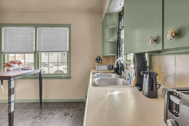 kitchen featuring green cabinets and sink