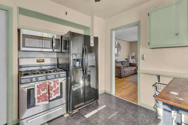 kitchen featuring green cabinets, dark hardwood / wood-style flooring, ornamental molding, and appliances with stainless steel finishes