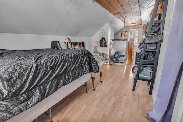 bedroom with light hardwood / wood-style floors and lofted ceiling