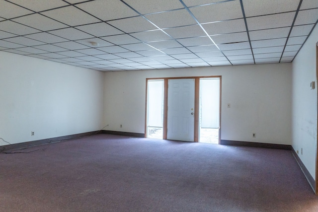 carpeted empty room with a drop ceiling