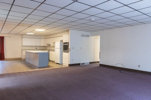 5620 Kaufman St, Dearborn Heights, MI 48125 - kitchen with stainless steel oven, freestanding refrigerator, light countertops, white cabinetry, and carpet