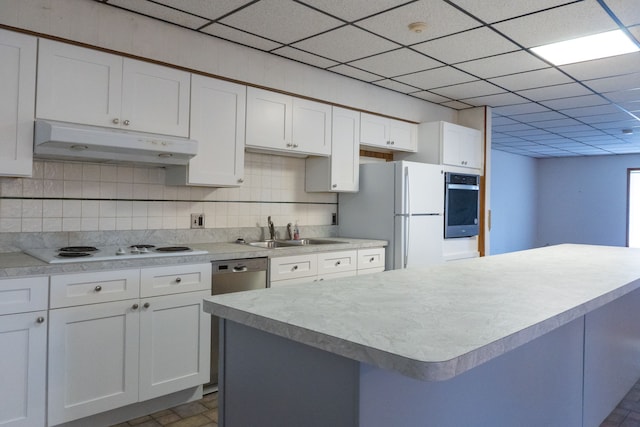 5620 Kaufman St, Dearborn Heights, MI 48125 - kitchen with under cabinet range hood, a sink, white appliances, white cabinetry, and a paneled ceiling