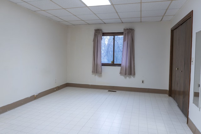 spare room featuring a paneled ceiling