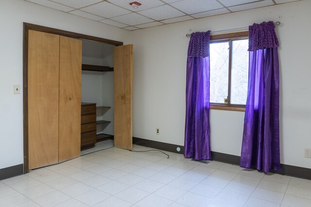 5620 Kaufman St, Dearborn Heights, MI 48125 - unfurnished bedroom featuring a paneled ceiling, a closet, light flooring, and baseboards