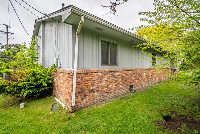 5620 Kaufman St, Dearborn Heights, MI 48125 - view of side of property with brick siding and a lawn
