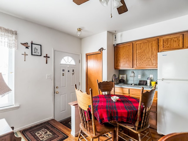 dining room with a wealth of natural light and wood-type flooring