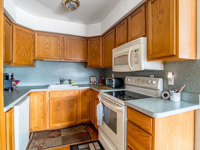 kitchen featuring sink and white appliances