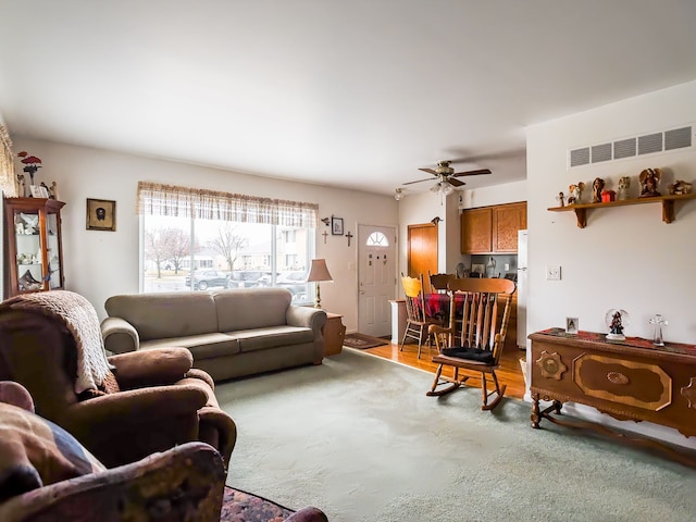 living room with light hardwood / wood-style floors and ceiling fan