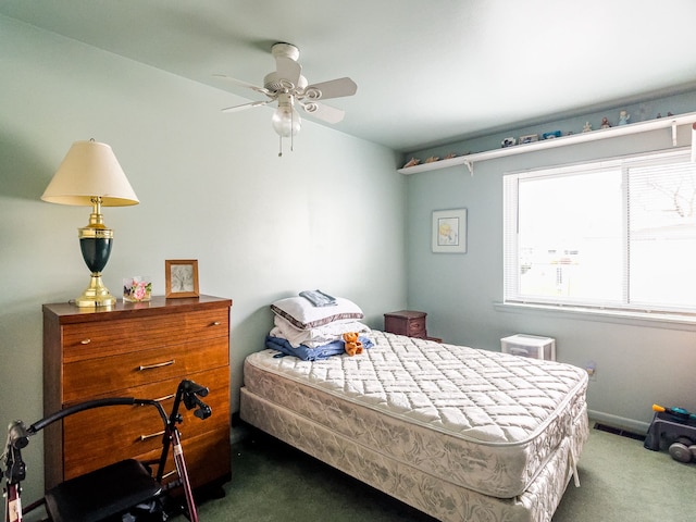 bedroom featuring ceiling fan and dark carpet