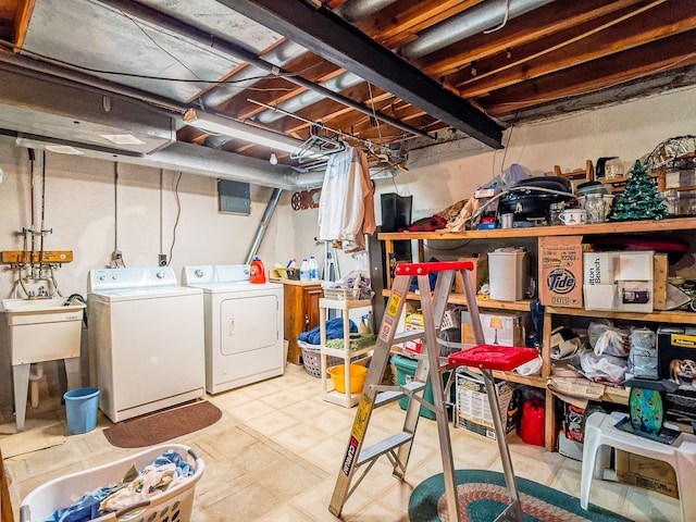 basement featuring washing machine and dryer and sink