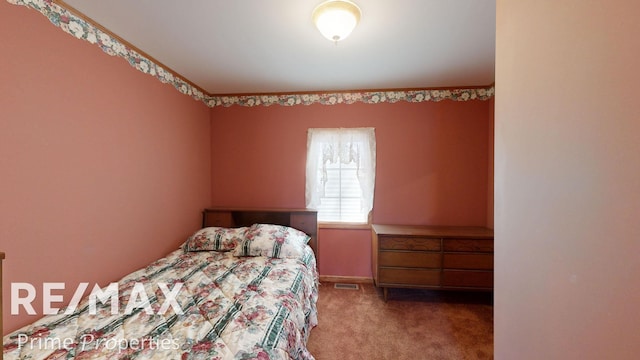 carpeted bedroom with visible vents and baseboards