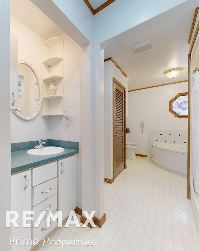 bathroom featuring crown molding, toilet, a garden tub, tile patterned floors, and vanity