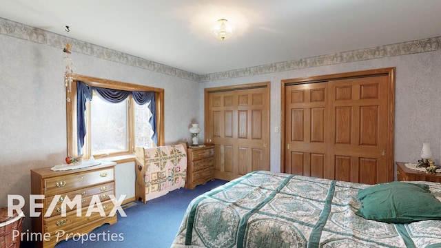 bedroom featuring multiple closets and carpet flooring