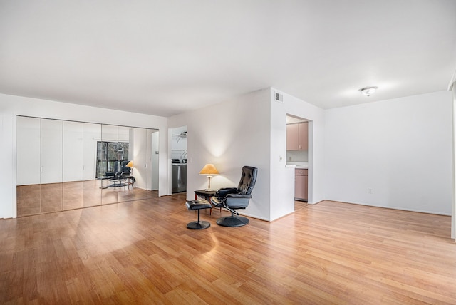 sitting room with light hardwood / wood-style flooring