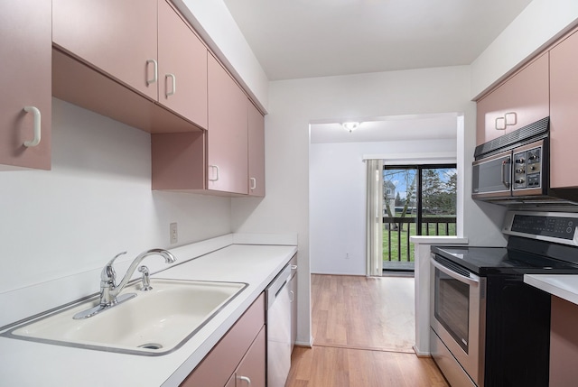 kitchen featuring light hardwood / wood-style floors, sink, and appliances with stainless steel finishes