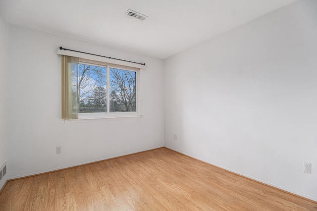 spare room with light hardwood / wood-style floors