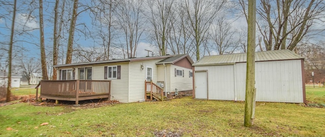 back of property with a lawn and a deck