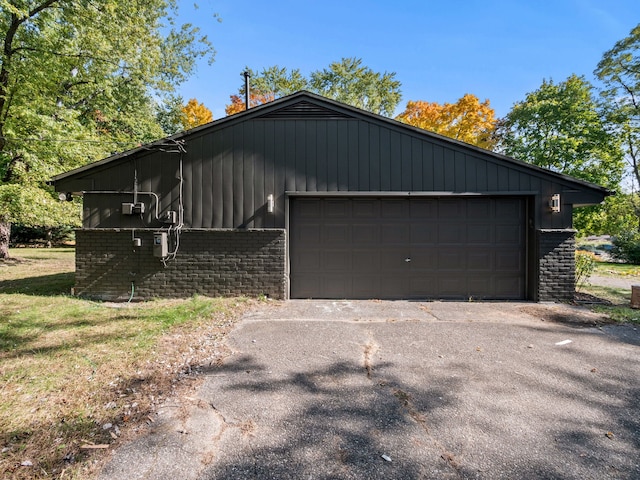 view of side of property featuring a garage and an outbuilding