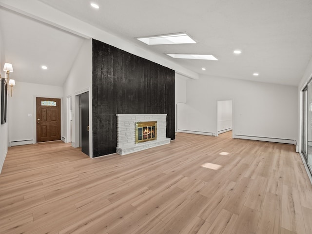 unfurnished living room with a large fireplace, beamed ceiling, light hardwood / wood-style floors, and a baseboard radiator