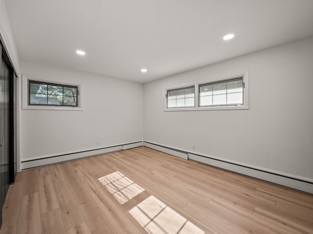 spare room with light hardwood / wood-style flooring and a baseboard heating unit