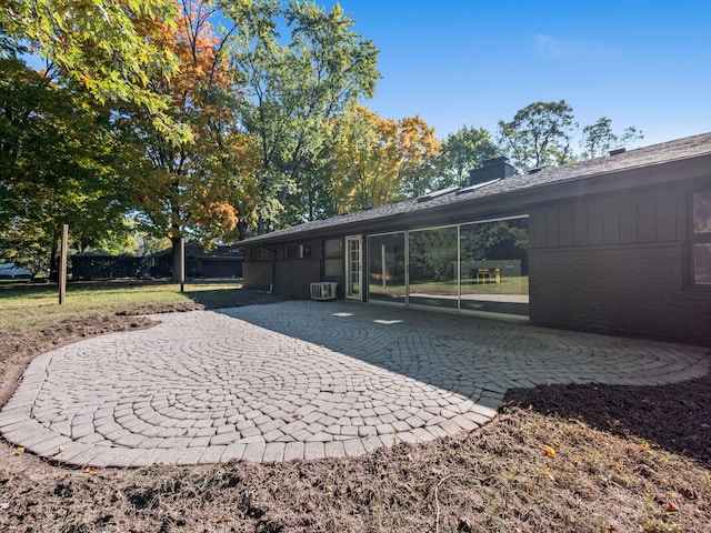 back of property featuring central AC and a patio area