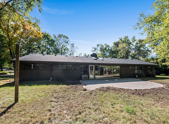 rear view of property featuring a yard