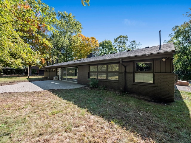 back of property featuring a yard and a patio