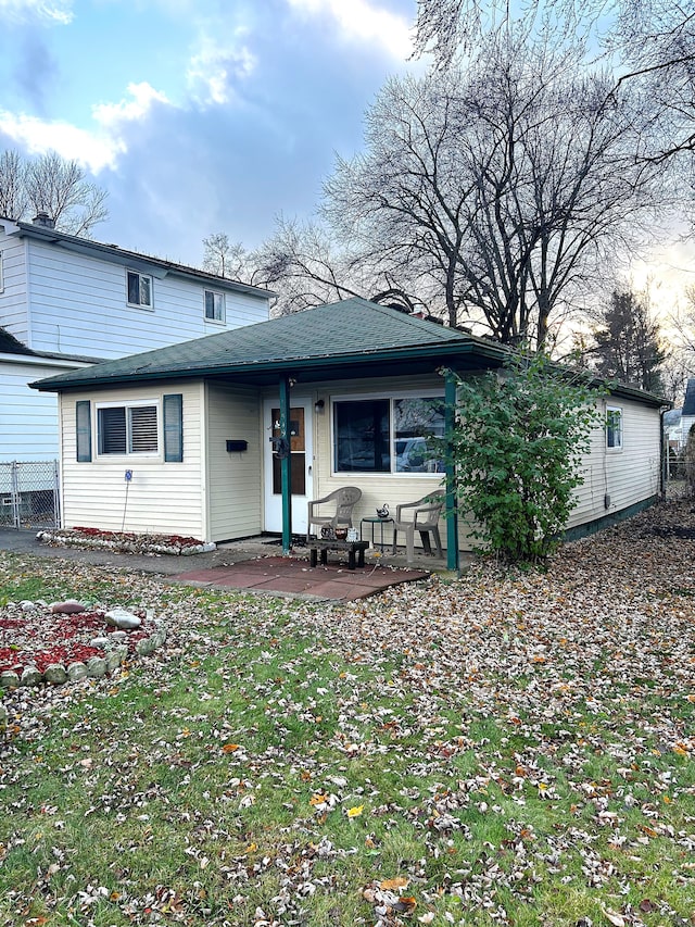 view of front of house with a front lawn and a patio area