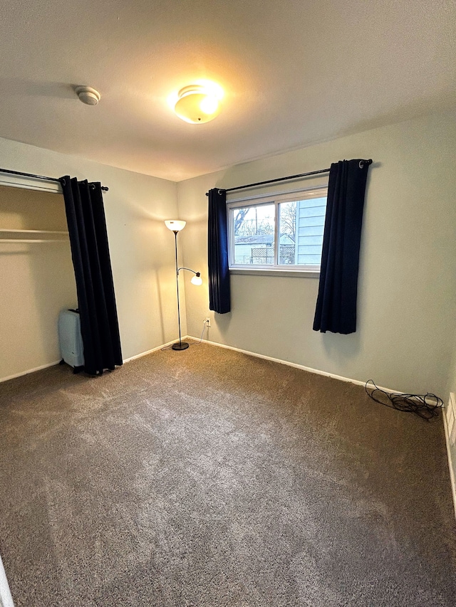 unfurnished bedroom featuring carpet flooring and a closet