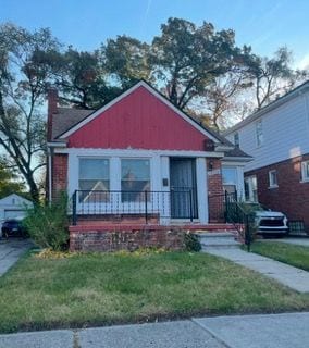 15750 Sorrento St, Detroit, MI 48227 - bungalow-style home with a front lawn and a chimney