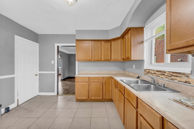 kitchen featuring light tile patterned floors and sink